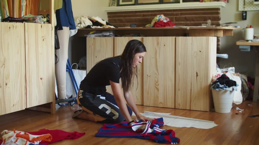A woman is cleaning up a room in her house