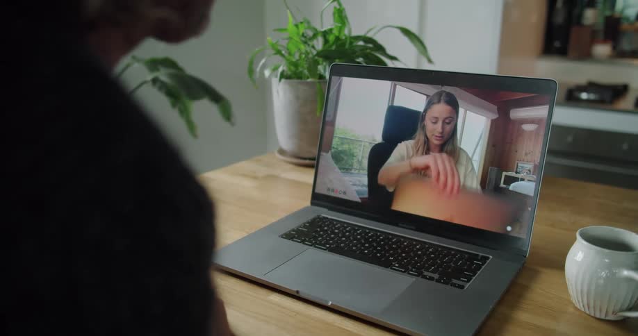 Two people having a relaxing conversation on a video call on a laptop