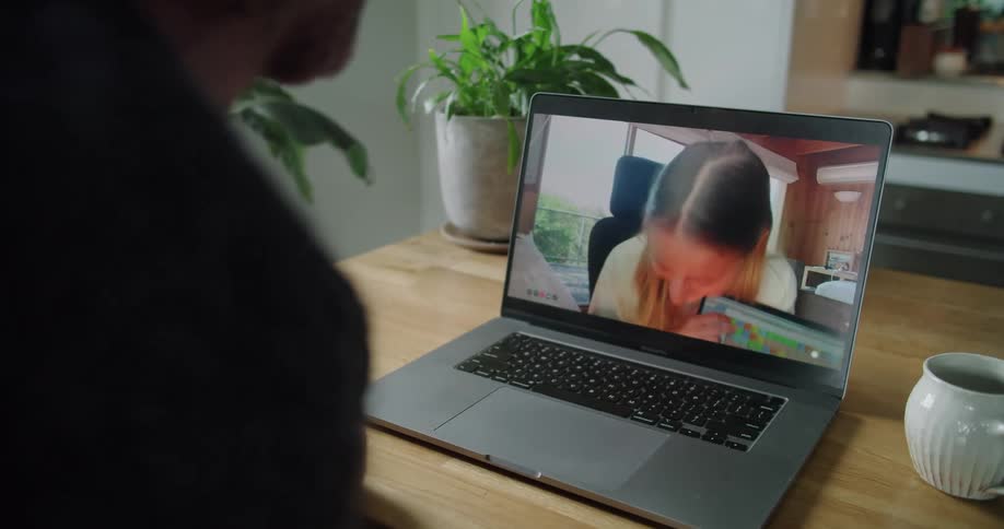 Woman showing a graphic on a laptop during a video call