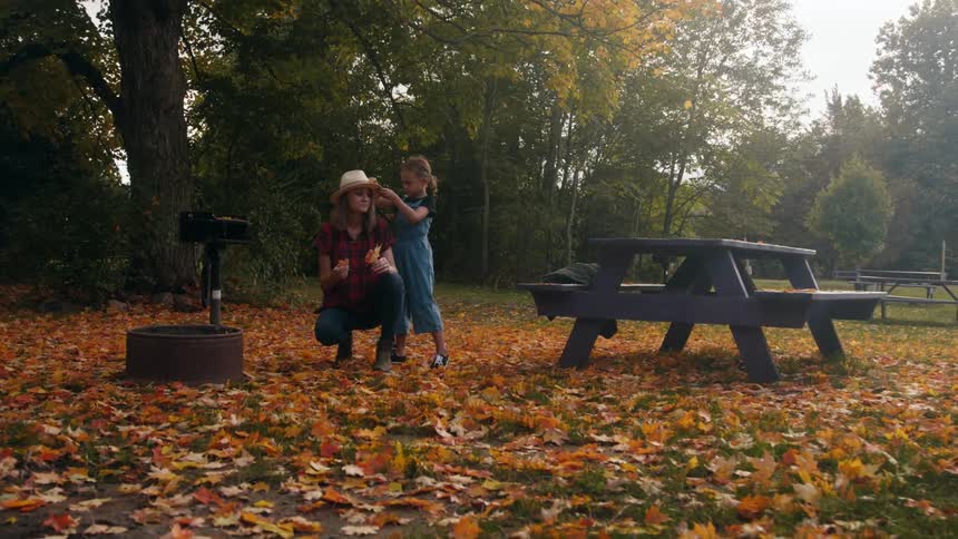 A mother and daughter playing in a park