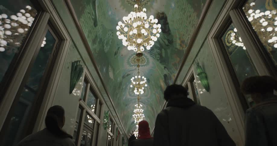 Group of people walking down a luxurious hallway