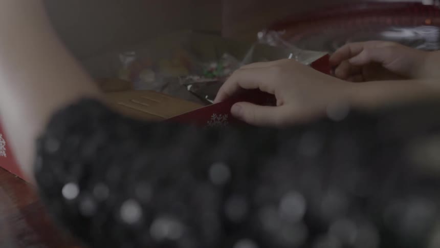 Children open a gingerbread house box
