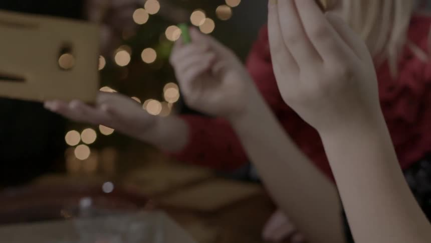 Two children put together a gingerbread house