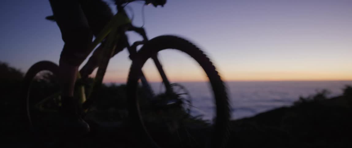 A bicyclist pedals hard in order to make it up a mountain trail