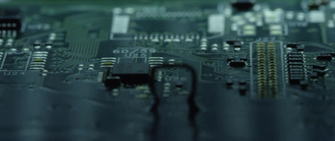 Close up of an electronic board reflecting moving white lights