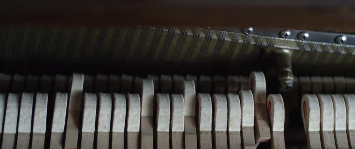 An interior shot of piano keys being played