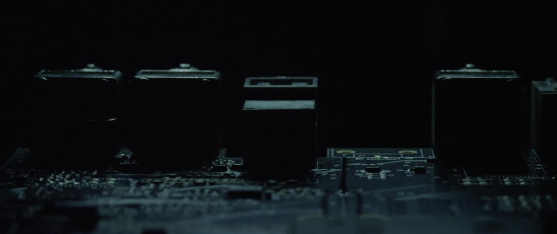 Close up of the electronic components on a board under a passing light