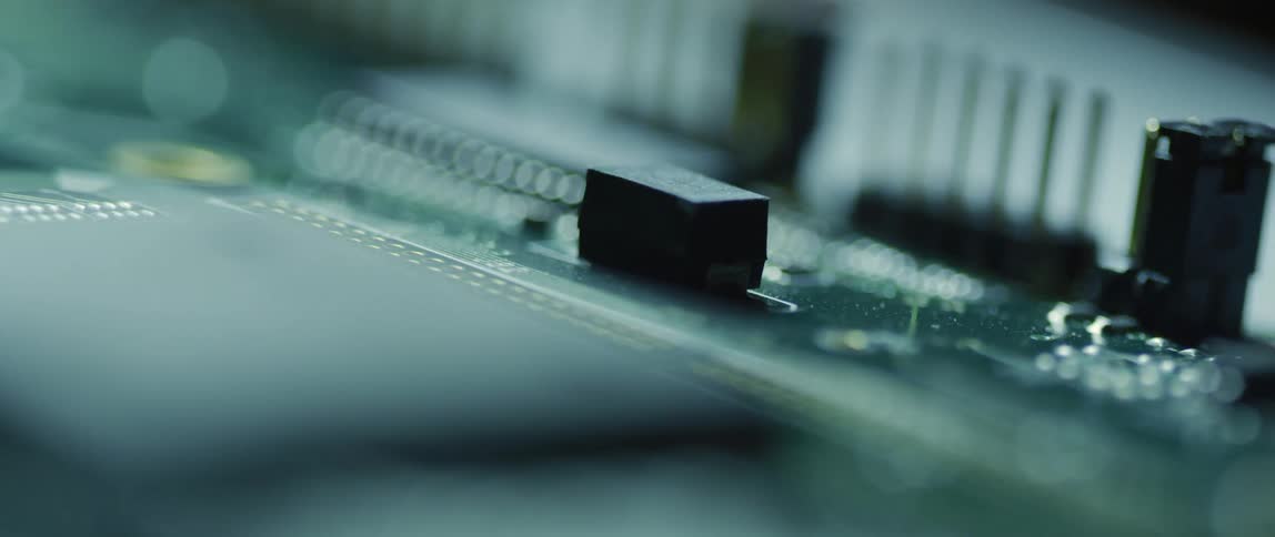 Electronic circuit board with black buttons and a green base