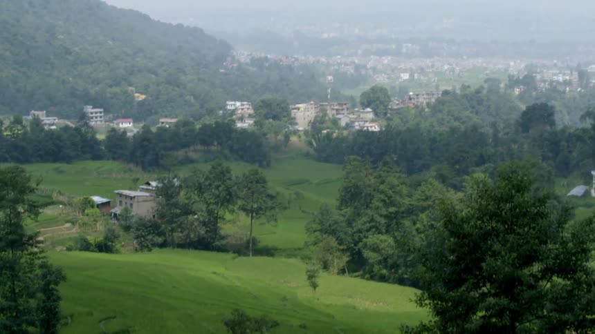 A city next to a forested mountain