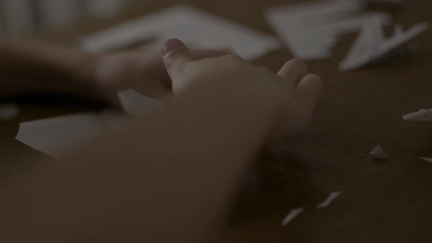 Person folding paper for their origami project