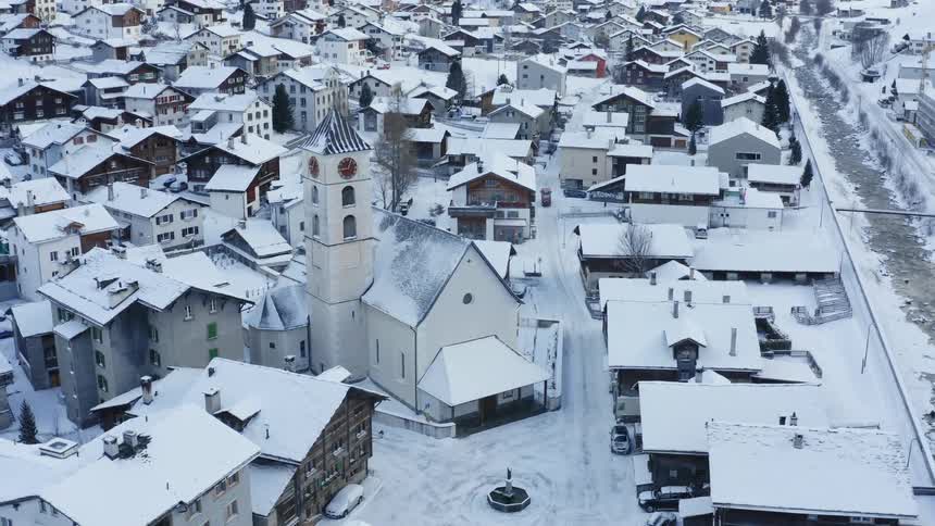 Snow is covering the rooftops in the neighborhood