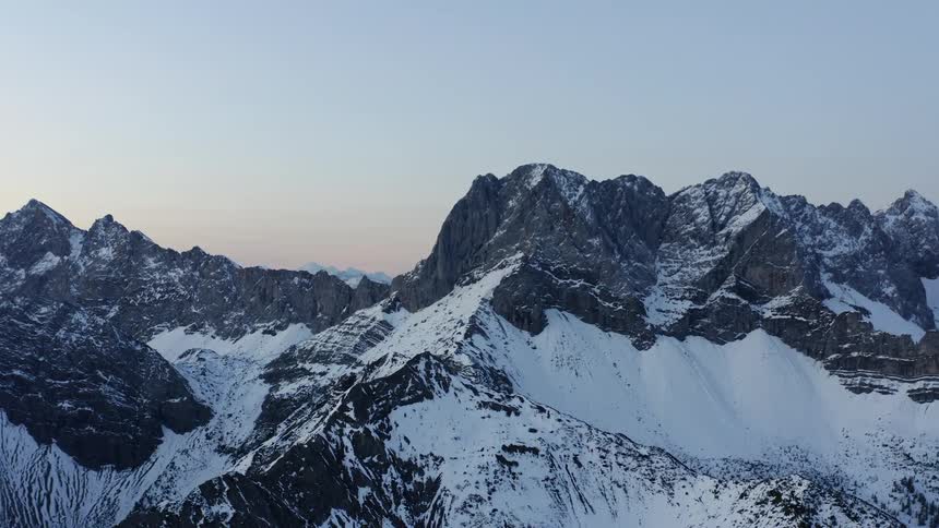 Aerial view of snow covered mountains are displayed