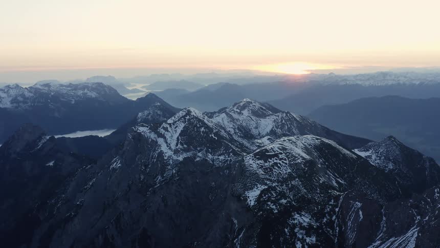 Aerial view of mountains covered in snow are displayed