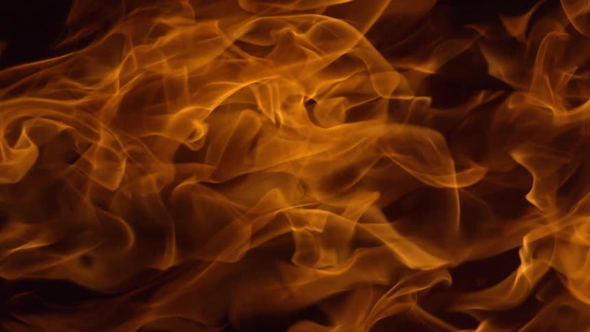 A bonfire is displayed at night