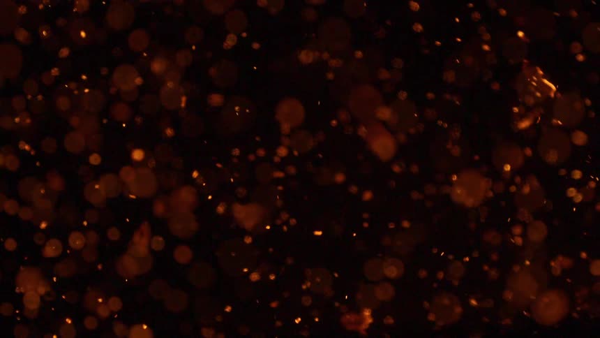 Fire with flames and embers in the air at night