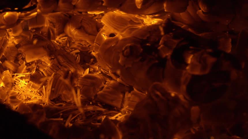 Fire burning red and orange where pieces chip off and float away