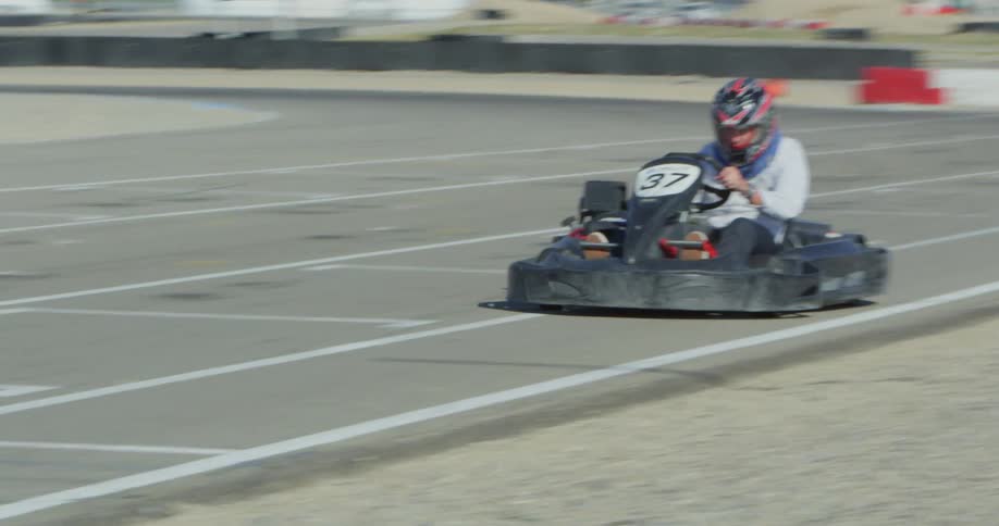 A person is racing a vehicle on a racetrack