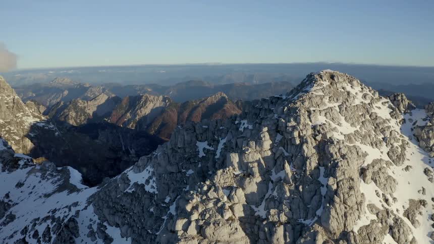 The frosted peak of a stone mountain on a sunny day