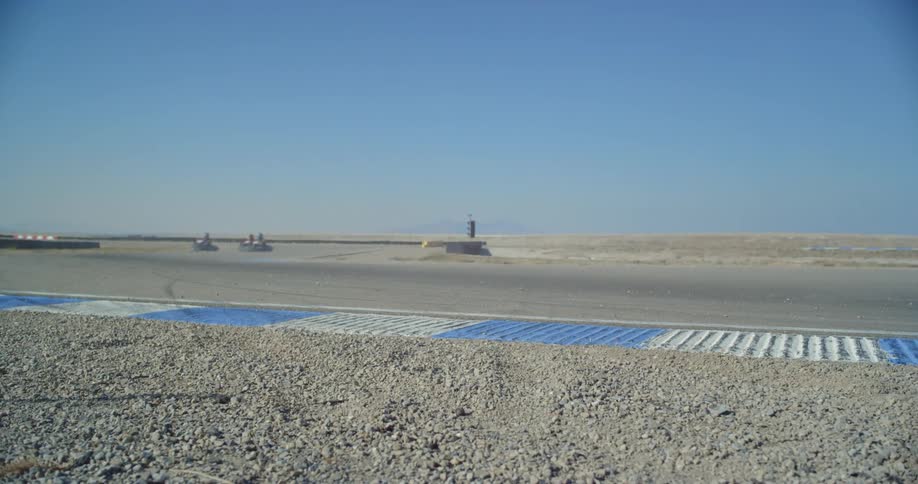 People racing go karts around a track