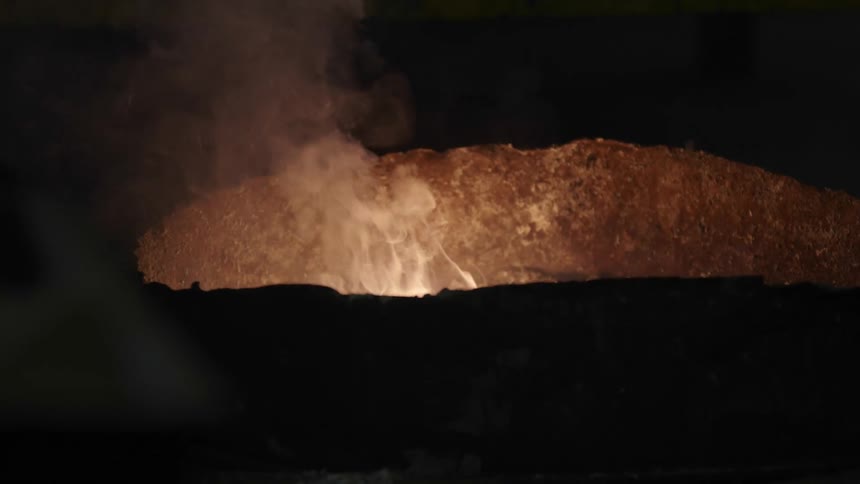 A fire pit with light and smoke emitting up