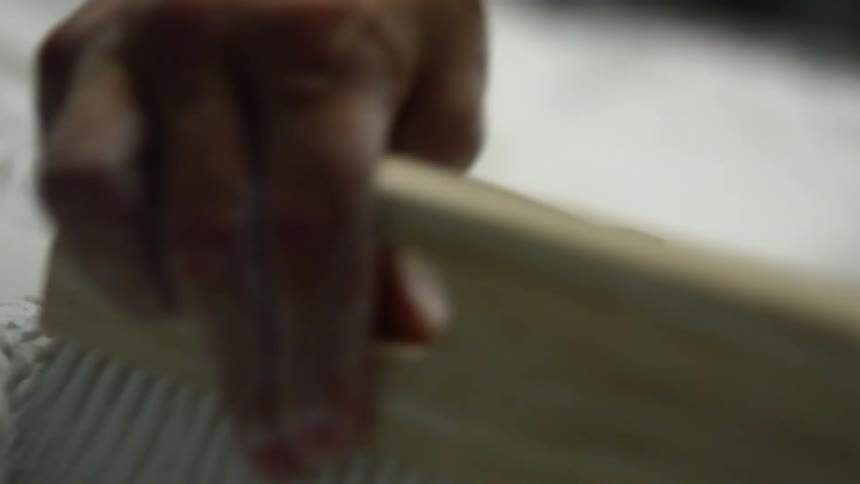 A person is brushing powder over a notch