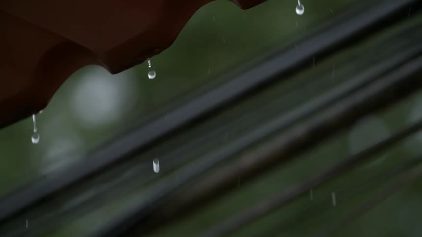 Water drips from the eaves of a building