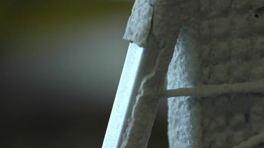 A hammer chipping away at frost on metal