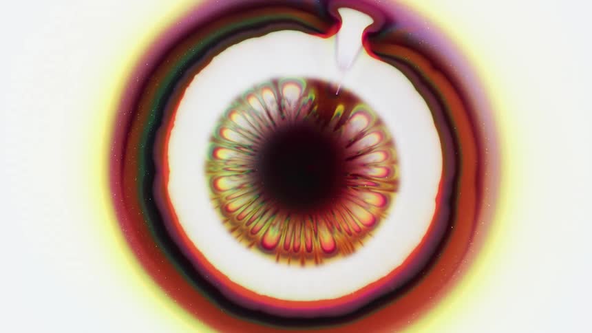 Flowing colorful liquid on a white surface