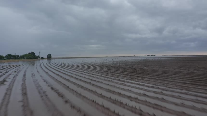 Aerial shot of fallow farm land being severly flooded after a heavy afternoon thunderstorm in rural Texas