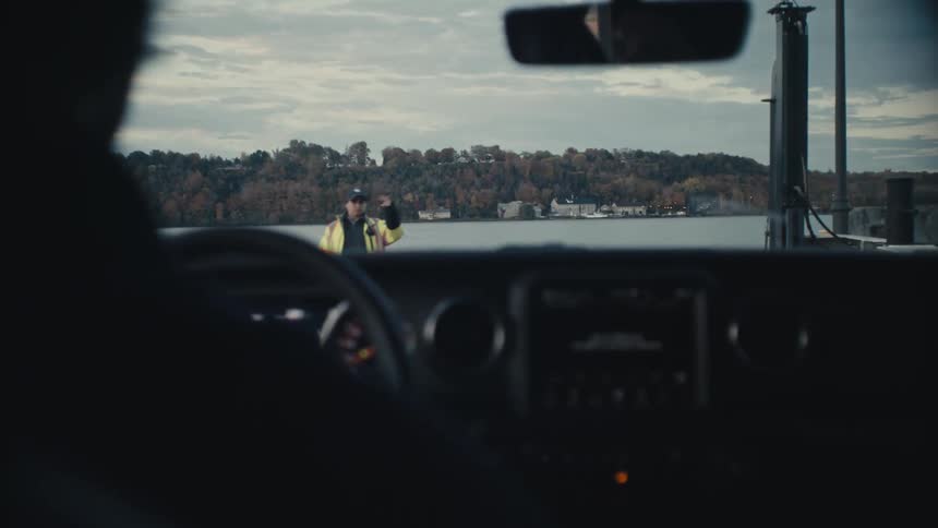 Point of view footage of a car parking over a barge in a lake
