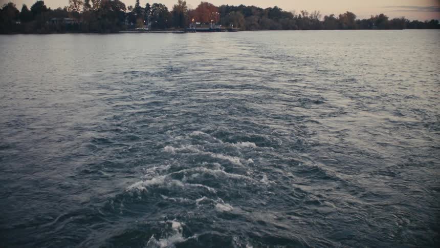 The boat is giving off waves as it travels in the lake