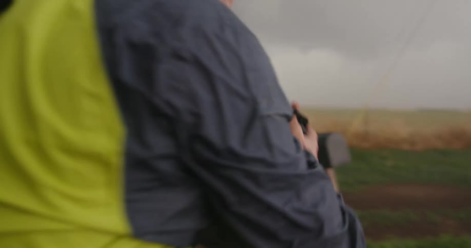 A storm chaser photographs a tornado during a fierce storm with extreme winds and strong rain on his bucket list expedition to see a tornado