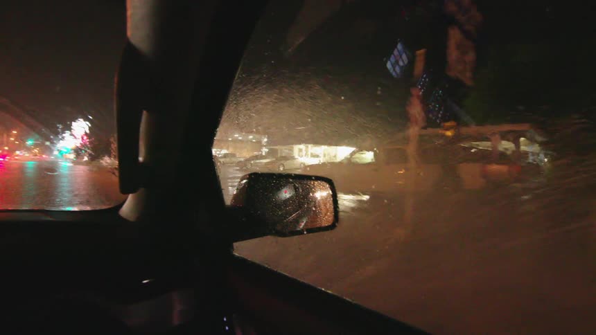 Lightning flashes as the vehicle drives on flooded roadways in Roswell, New Mexico as severe thunderstorms drop intense amount of rain