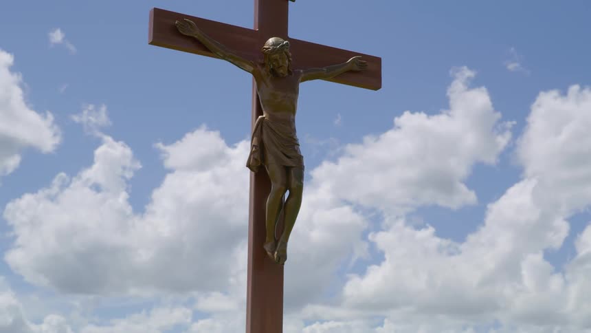 Time lapse of the cross bearing Jesus Christ with storm clouds blowing and building in the background