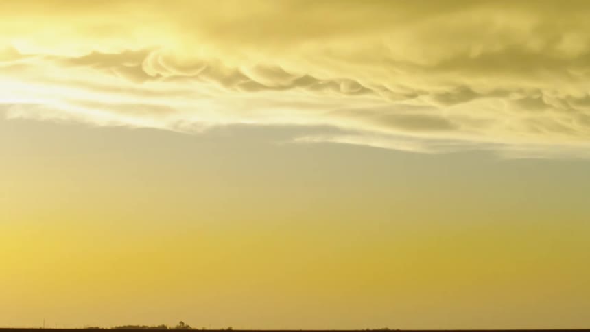Time lapse of mammatus storm clouds at sunset moving from left to right as a huge thunderstorm leaves rural Texas after dumping rain and hail