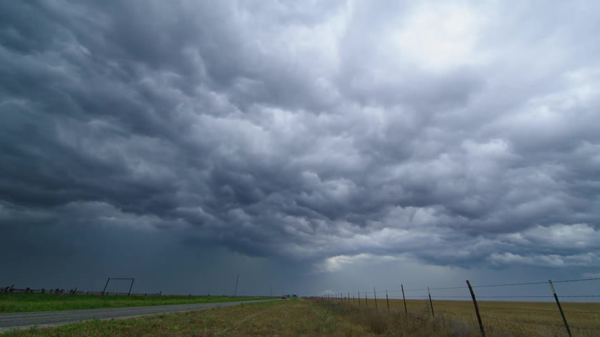 Time lapse of ocean like storm clouds crashing and cascading across the afternoon sky in rural Texas