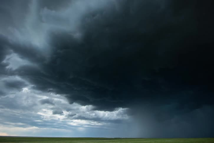 Time lapse of dark boiling and ominous severe thunderstorm and supercell clouds careening towards camera