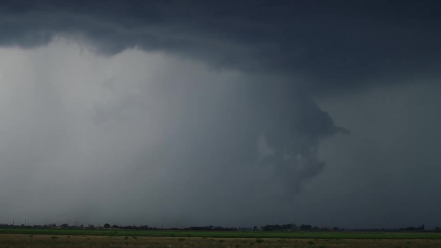 Tight shot time lapse of a severe rotating convective supercell storm funnel cloud and cloudburst with heavy rain and hail