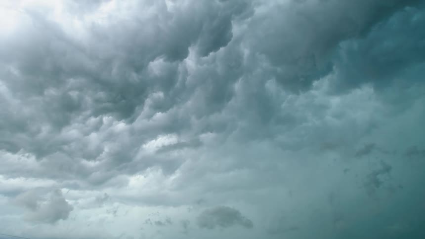 Time lapse shot looking straight up into boiling and rolling severe super cell thunderstorm clouds in this eerie and ominous shot