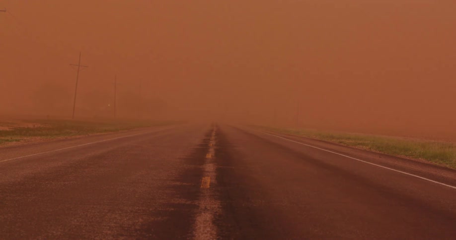 A Haboob desert wind dust storm overwhelms a rural highway with blowing sand and dust in this severe weather ominous and spooky moment