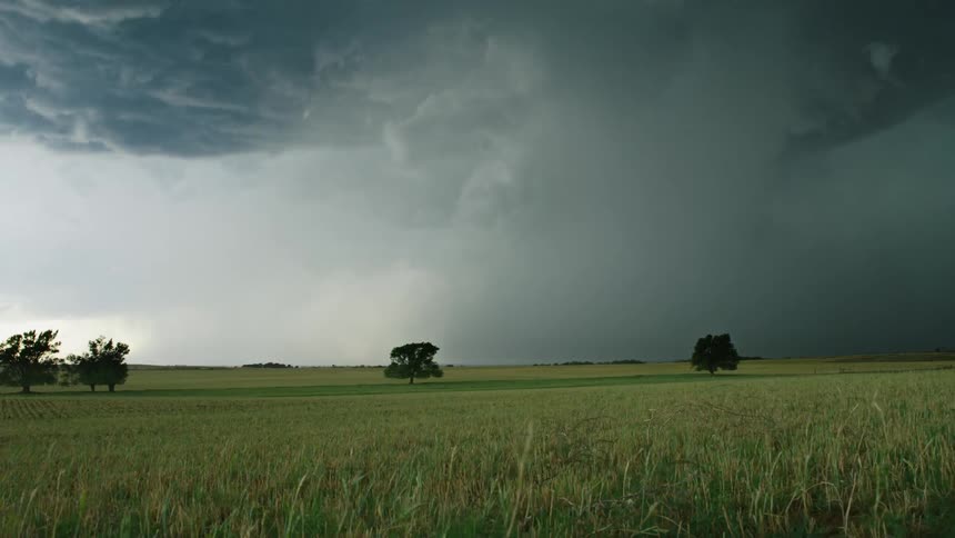 Time lapse of a supercell thunderstorm cloudburst extreme rain event as the storm boils and rotates towards camera