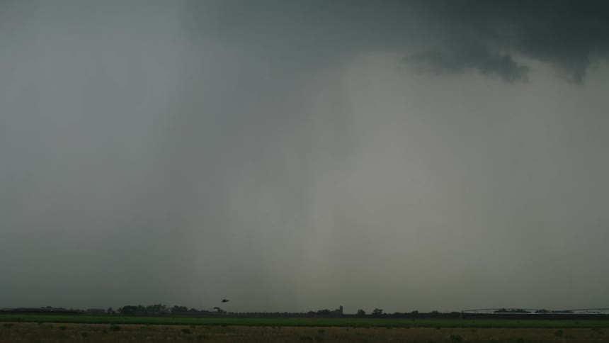 Time lapse of a heavy precipitation thunderstorm cloudburst of rain and hail over the arid New Mexico agricultural land