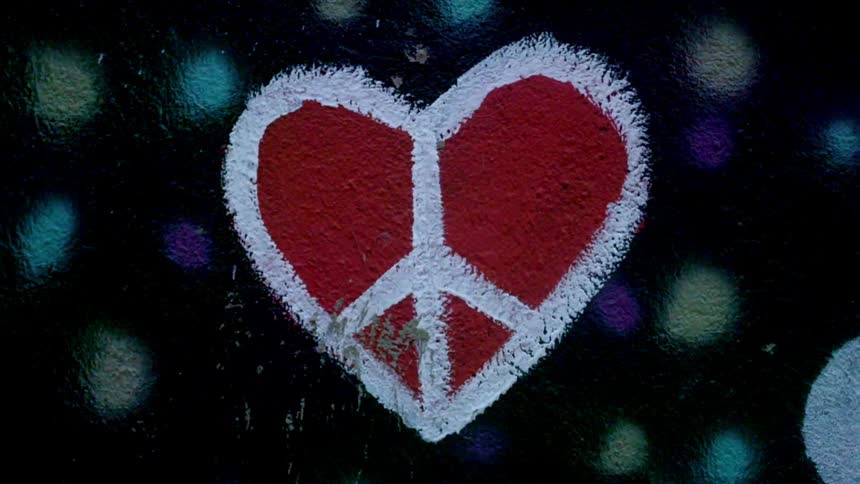 Close up of a heart shaped drawing with a peace sign in it