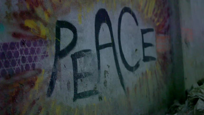 The word "peace" painted on a wall