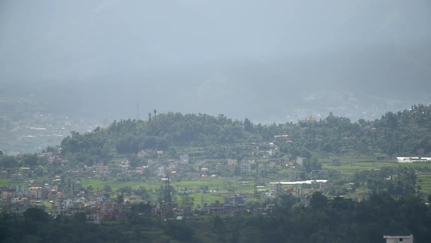 A town on a hillside on a hazy day