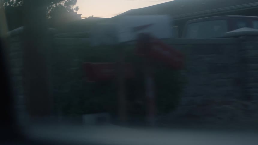Houses on a neighborhood seen through the fogged window of a car at morning