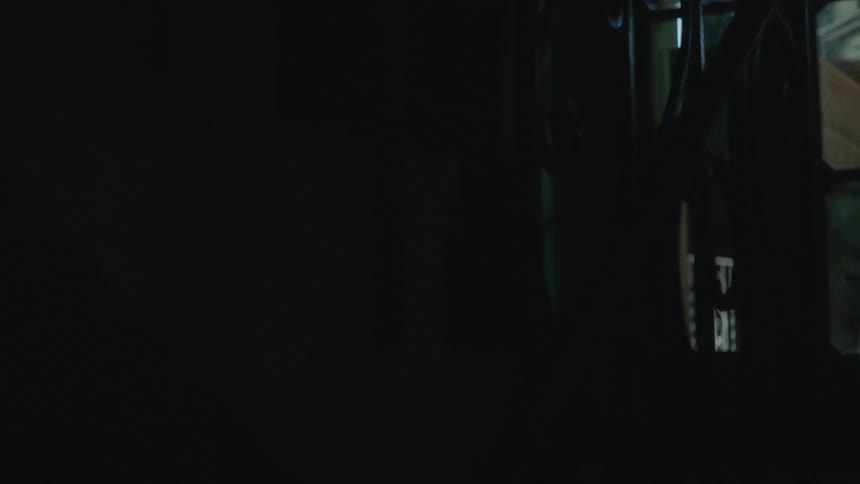 A person running stairs with flashing lights in the darkness