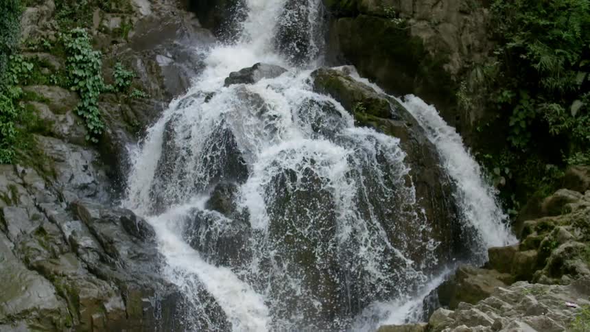 A waterfall is pouring water down over some rocks