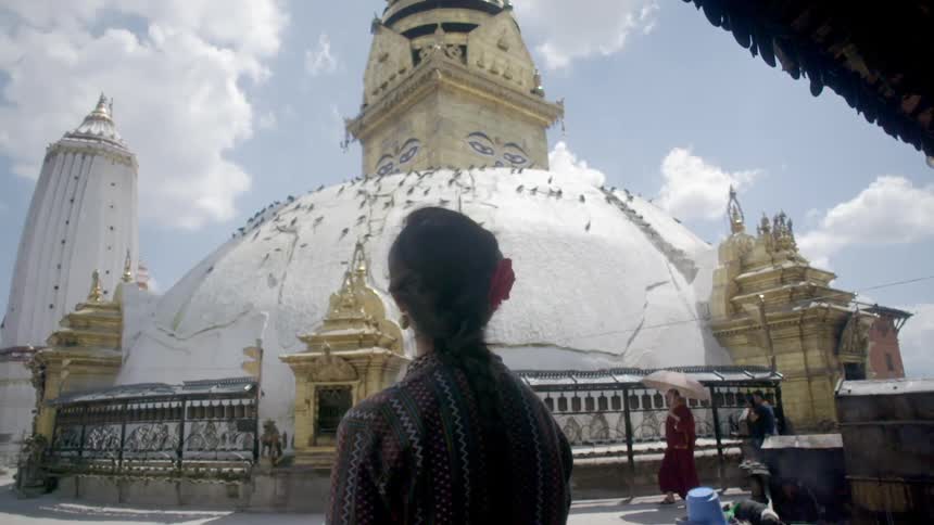 Woman looking up at a temple