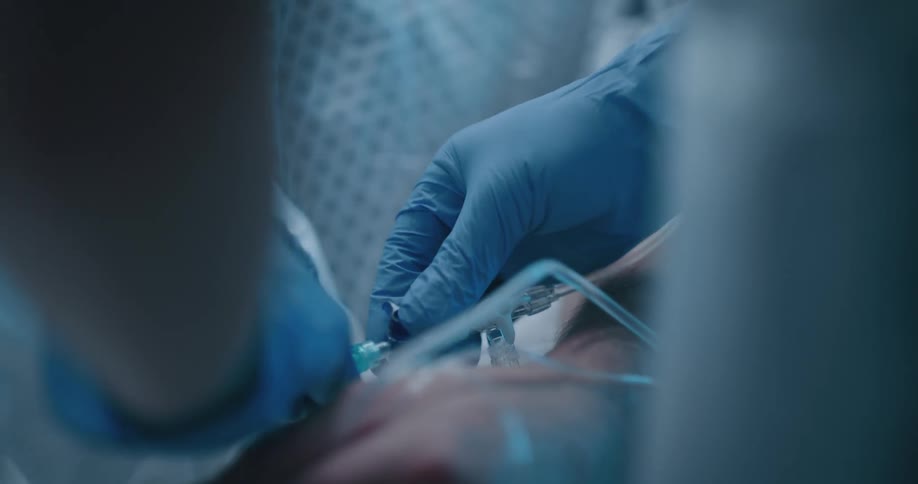 A nurse connecting an iv to a hospital patient